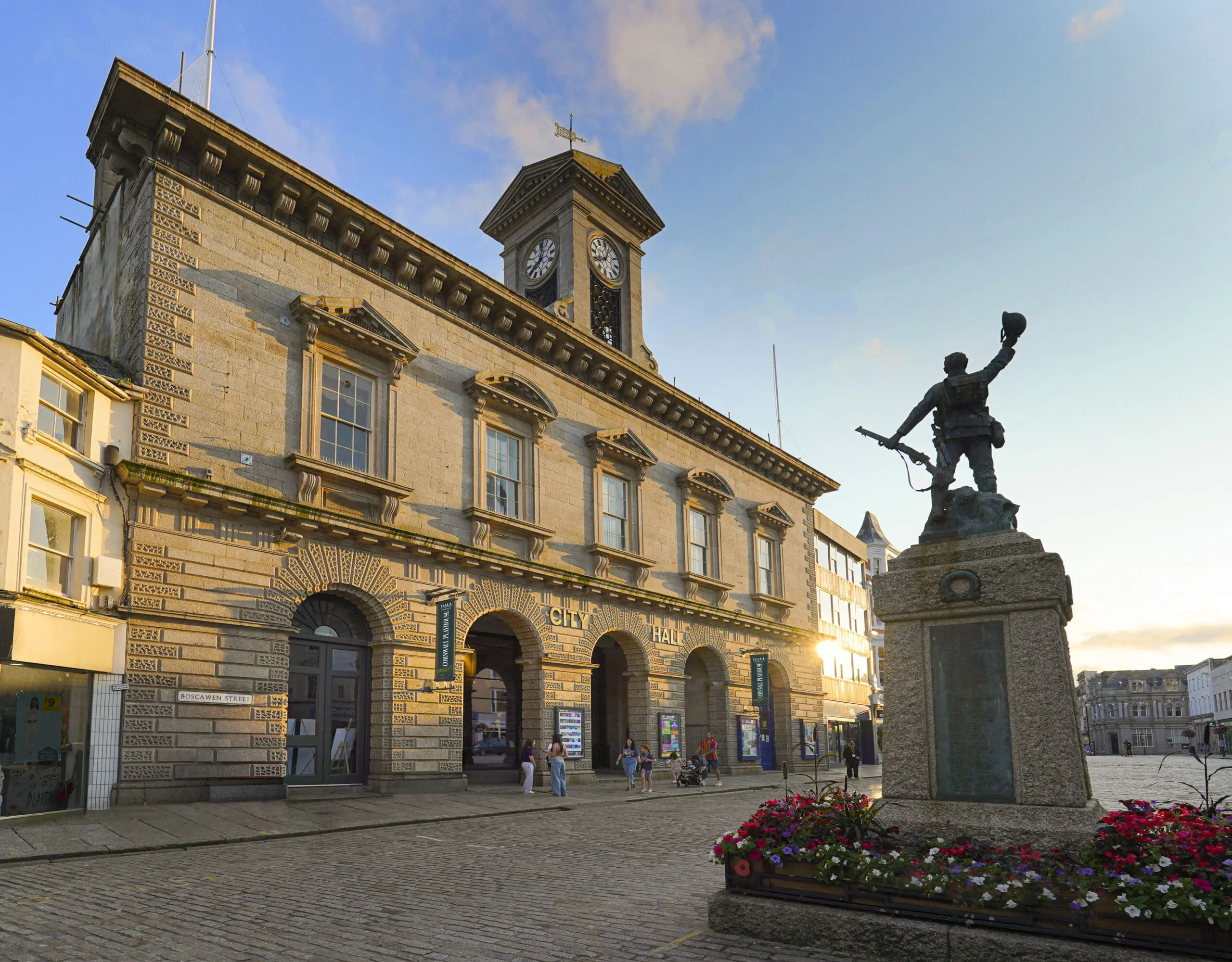 A period building with a statue on a plinth outside