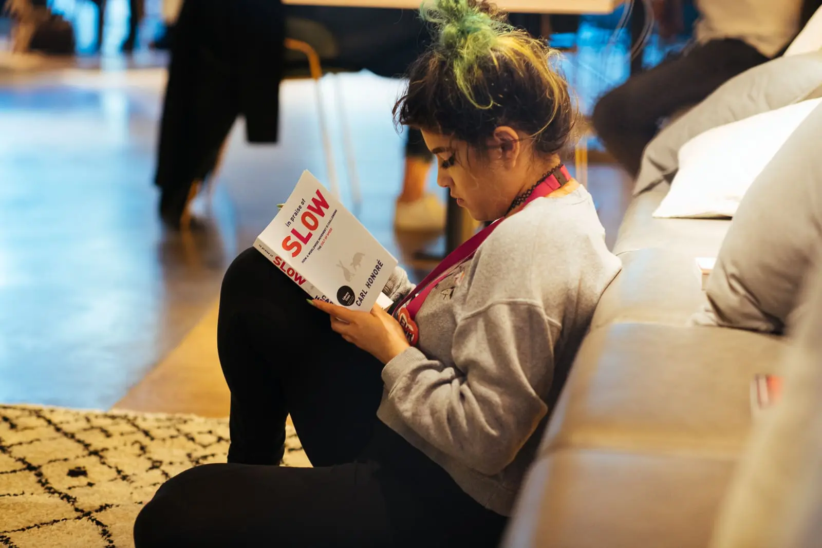 Person sat down on floor reading book