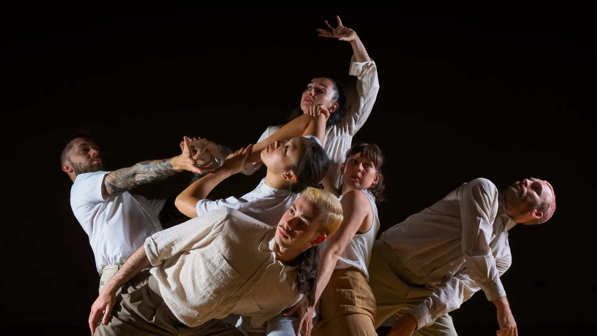people dancing on stage, black background