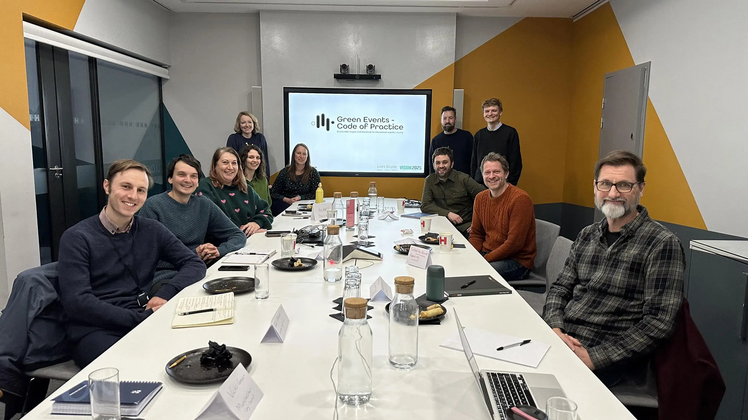 GECOP Kick Off Meeting A group of people sitting around a table in a meeting room smiling