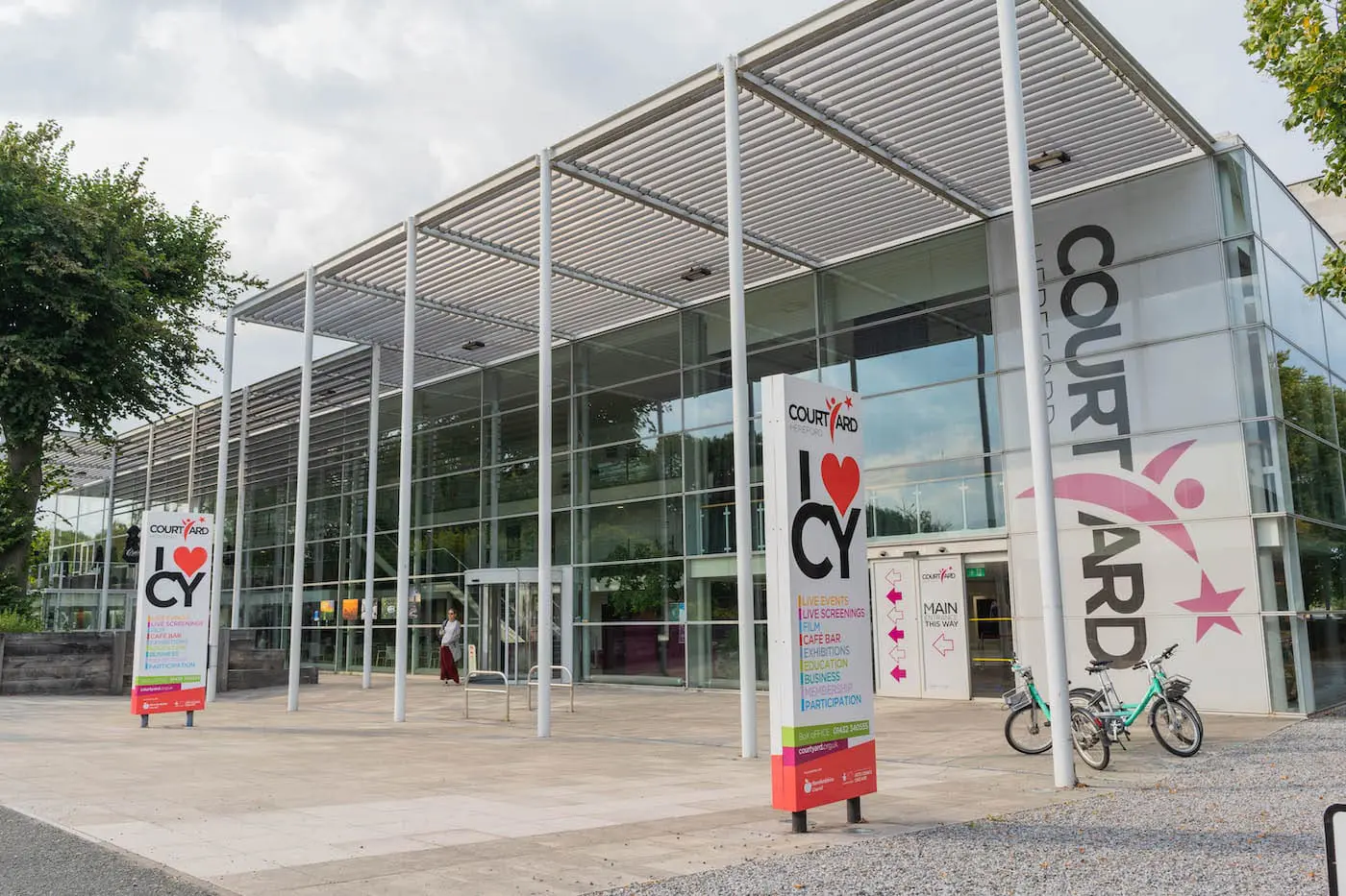 Modern building with floor to ceiling glass windows against a grey sky