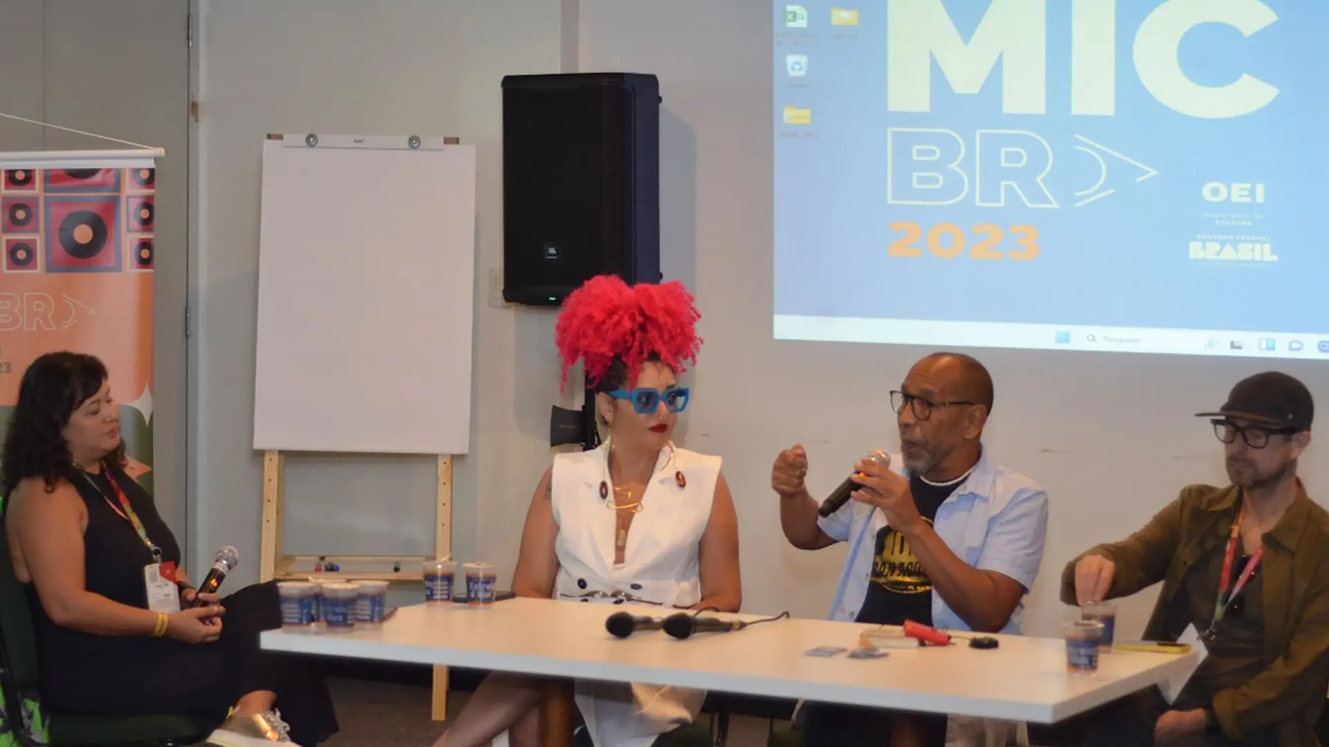 Panel session with four people sitting down and discussing