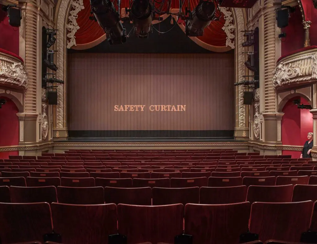shot of stage, red chairs and safety curtain