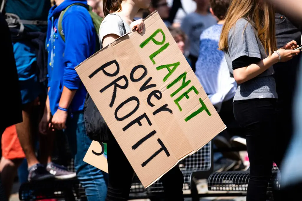 A protest sign saying Planet Over Profit