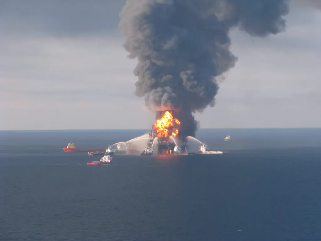 Fire boat response crews battle the blazing remnants of the offshore oil rig Deepwater Horizon in 2010, after an uncontrolled urge of methane gas caused an explosion, leaving the seabed well gushing an estimated 3.19 millions barrels of oil over 87 days. Image credit: US Coast Guard.